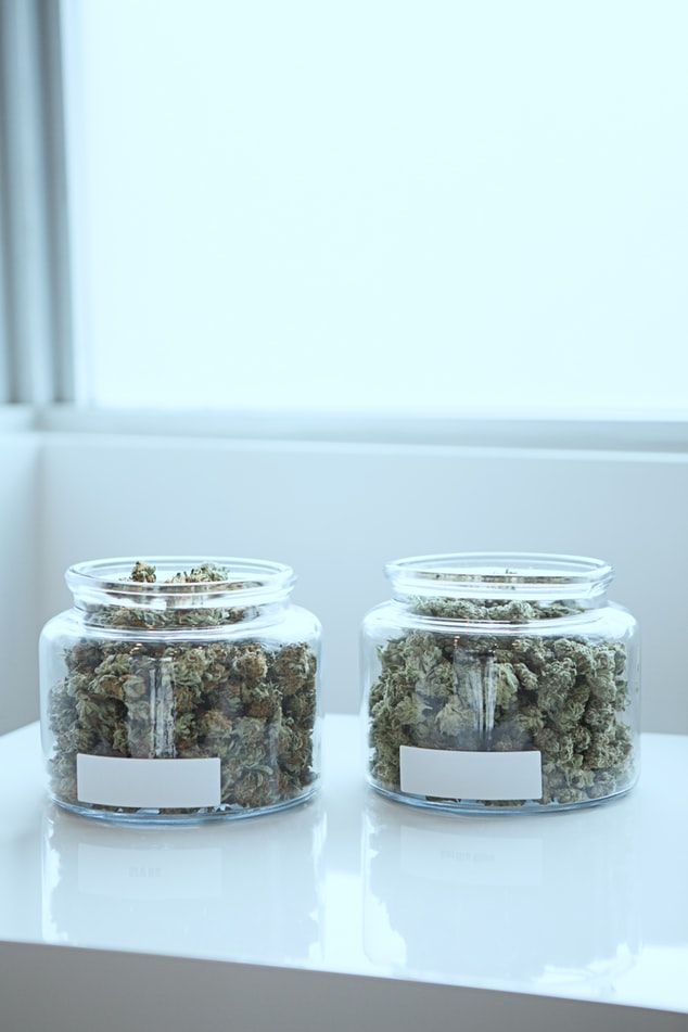 Two glass jars with cannabis inside