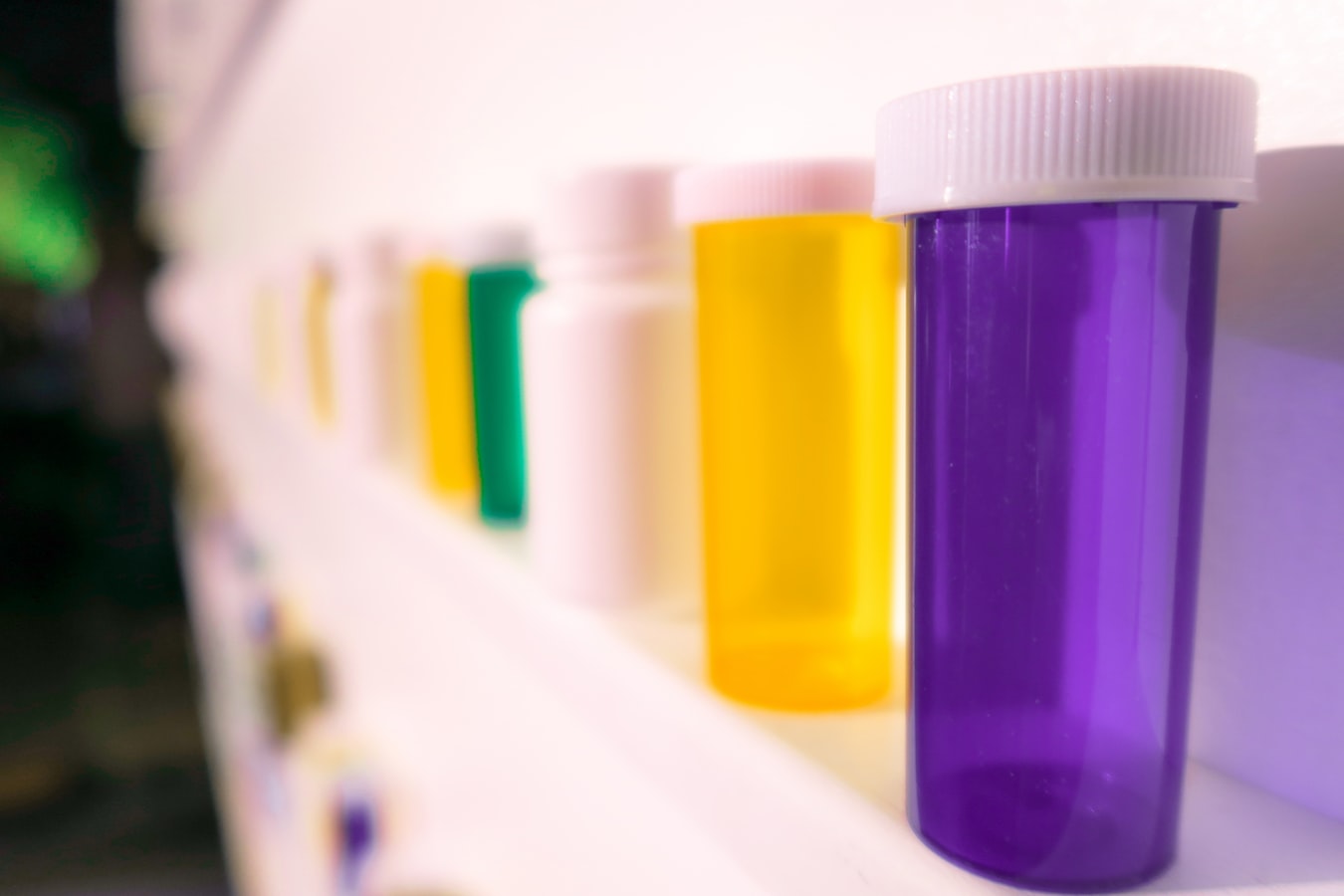 Colorful pill bottles on a shelf